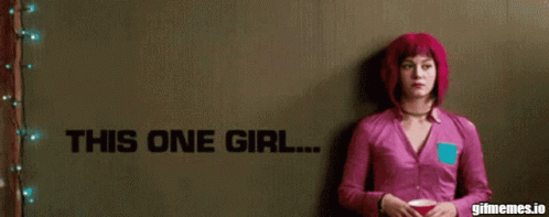 Woman in Pink Shirt in Front of His One Girl Wall