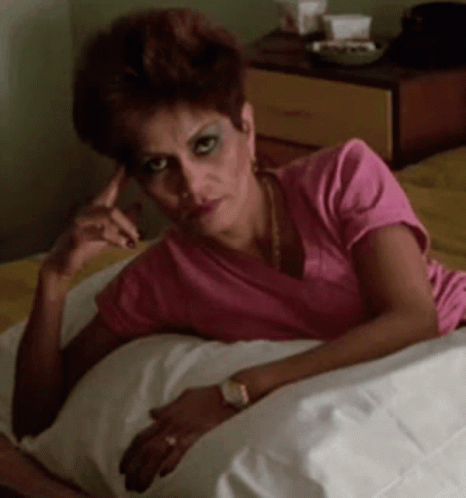 Woman in Pink Shirt Lying on Bed