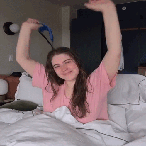 Woman in Pink Shirt Lying on Bed