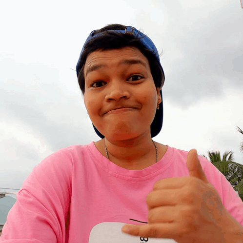 Woman in Pink Shirt Number 33 Giving Thumbs Up