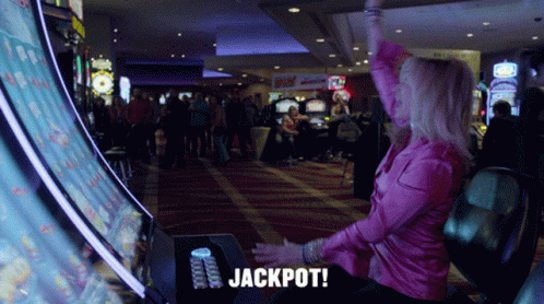 Woman In Pink Shirt Playing Slot Machine GIF