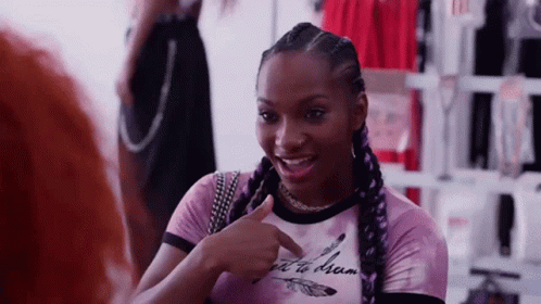 Woman In Pink Shirt Pointing And Talking To Another Woman GIF