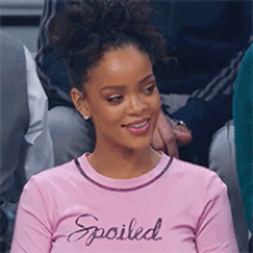 Woman In Pink Shirt Saying Spoiled Sitting In Crowd GIF