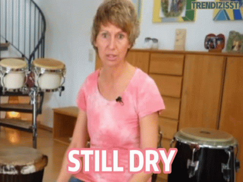 Woman in Pink Shirt Saying Still Dry