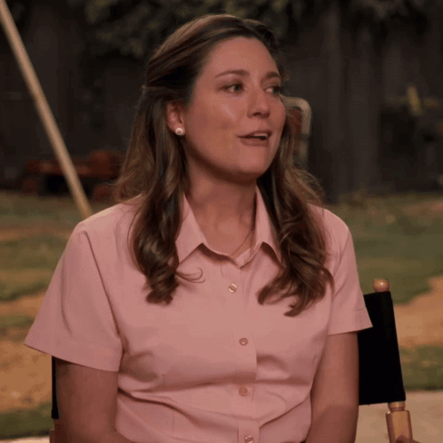 Woman in Pink Shirt Sitting in Director's Chair