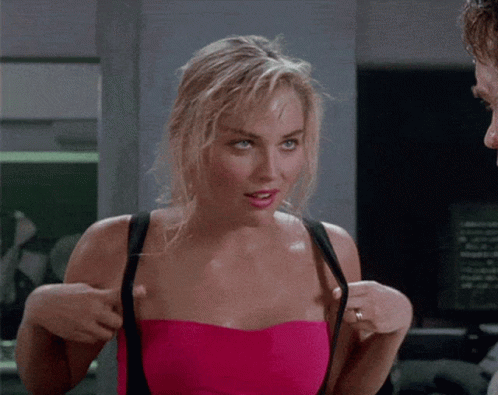 Woman in Pink Strapless Top Adjusting Bra Straps