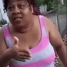 Woman in Pink Striped Tank Top Giving Thumbs Up