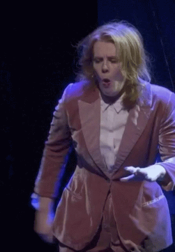 Woman in Pink Suit on Stage