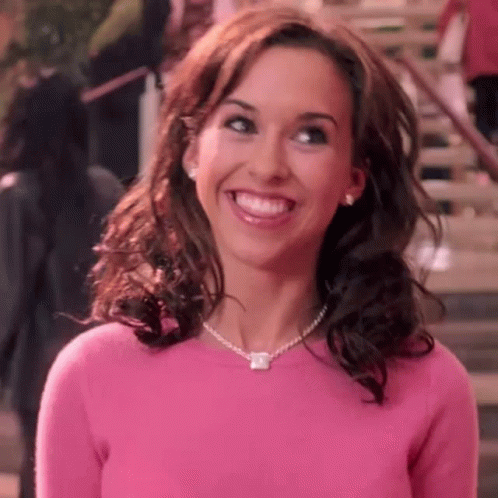 Woman In Pink Sweater And Necklace Smiling GIF