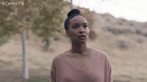 Woman in Pink Sweater in Field