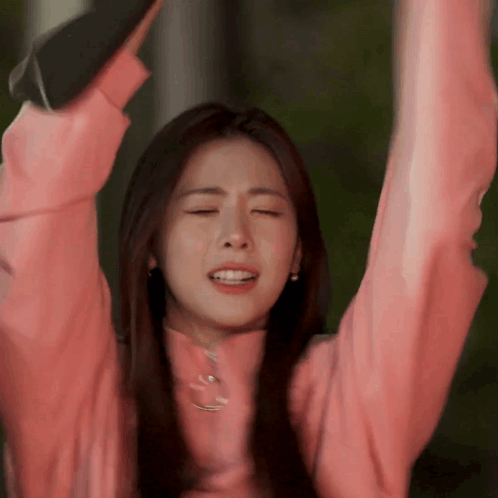 Woman in Pink Sweater Raising Arms