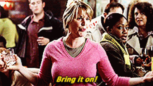 Woman in Pink Sweater Saying Bring It On in Yellow