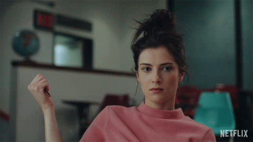 Woman in Pink Sweater With Netflix Logo