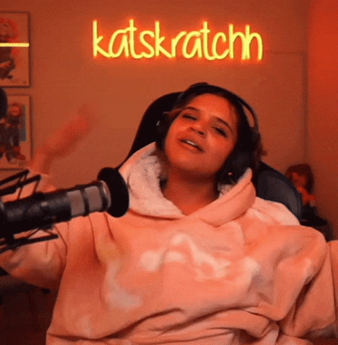 Woman in Pink Sweatshirt and Headphones at Katskratchn