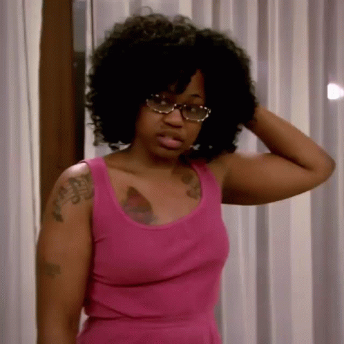 Woman in Pink Tank Top and Glasses Holding Hair