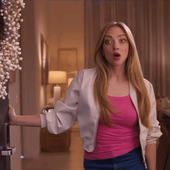 Woman in Pink Tank Top and White Jacket by Door
