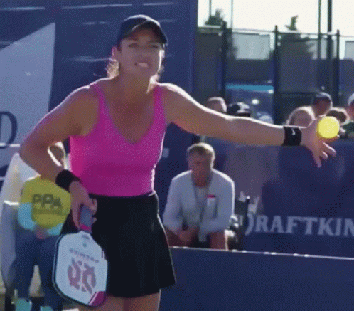 Woman in Pink Tank Top Holding Tennis Ball and Paddle With 60