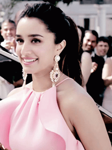 Woman in Pink Top and Earrings Smiling