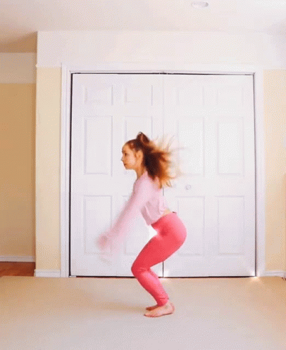 Woman In Pink Top And Pink Pants Jumping GIF