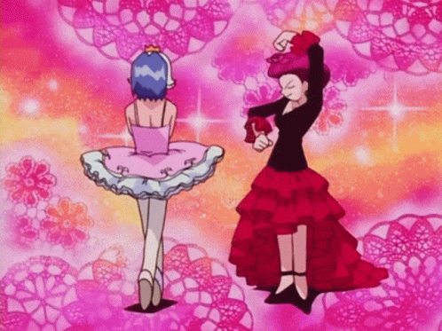 Woman in Pink Tutu Next to Woman in Red Skirt