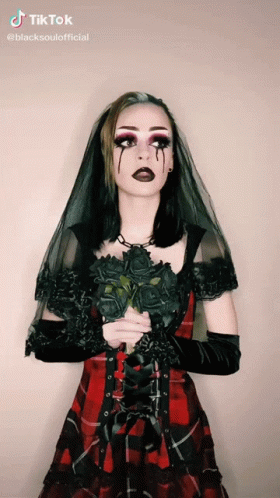 Woman in Plaid Dress Holding Black Roses