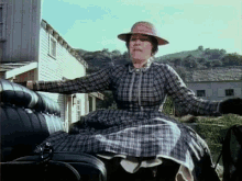 Woman in Plaid Dress Riding Carriage