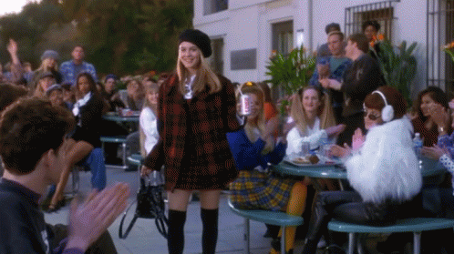 Woman in Plaid Jacket Before Crowd