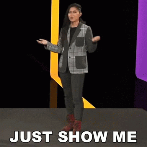 Woman in Plaid Jacket on Stage Saying Just Show Me