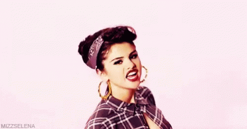 Woman In Plaid Shirt And Hoop Earrings Making Funny Face GIF