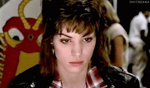 Woman in Plaid Shirt and Leather Jacket Ohitsdana