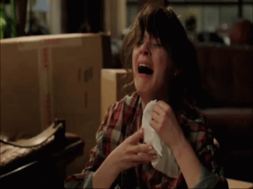 Woman in Plaid Shirt Crying with Napkin