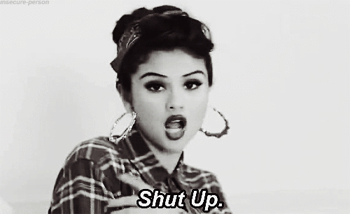 Woman In Plaid Shirt Giving Middle Finger Saying Shut Up GIF