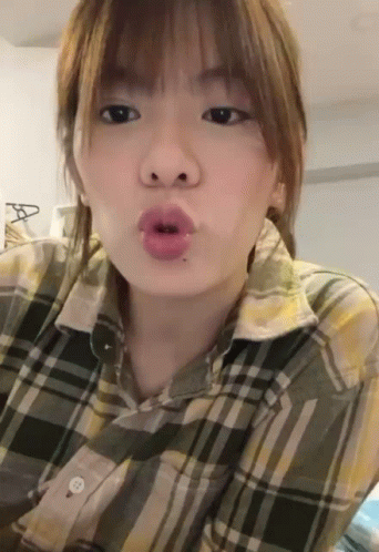 Woman in Plaid Shirt Making Face