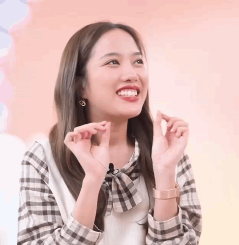 Woman in Plaid Shirt Making Heart With Hands