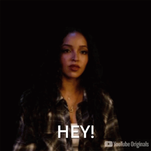 Woman in Plaid Shirt Saying Hey