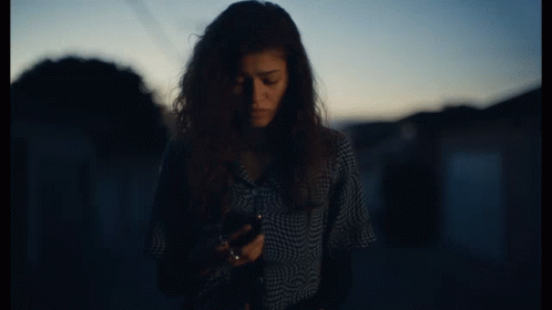 Woman in Plaid Shirt Talking on Cellphone