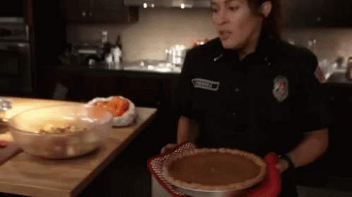 Woman in Police Uniform Holding Pumpkin Pie