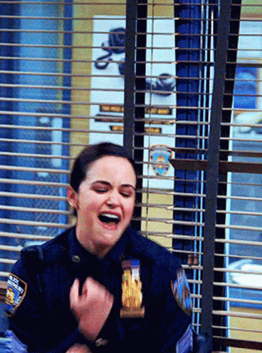 Woman in Police Uniform Laughing Behind Window