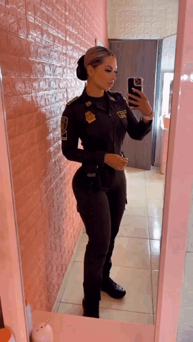 Woman In Police Uniform Taking Selfie In Mirror GIF