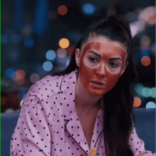 Woman in Polka Dot Pajama Shirt and Red Face Mask