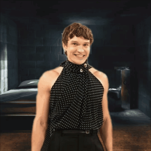 Woman in Polka Dot Top Smiling Behind Bars