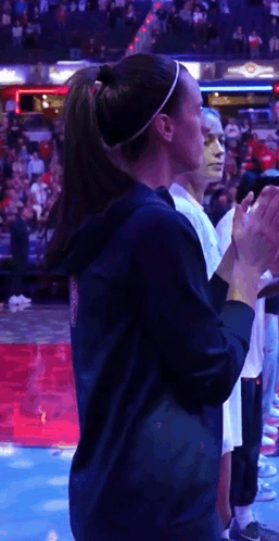 Woman in Ponytail Applauding Basketball Game