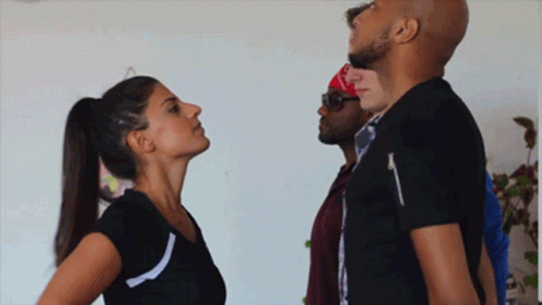 Woman In Ponytail Looking Up At Man In Black Shirt GIF