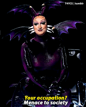 Woman in Purple and Black Costume Saying Your Occupation