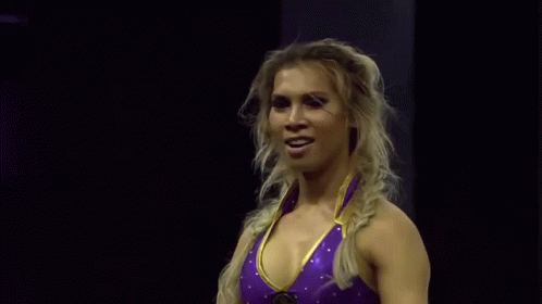 Woman in Purple and Gold Wrestling Outfit Waving