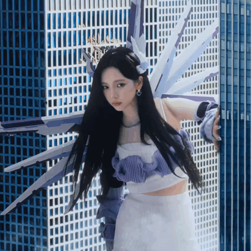 Woman in Purple and White Outfit by Building