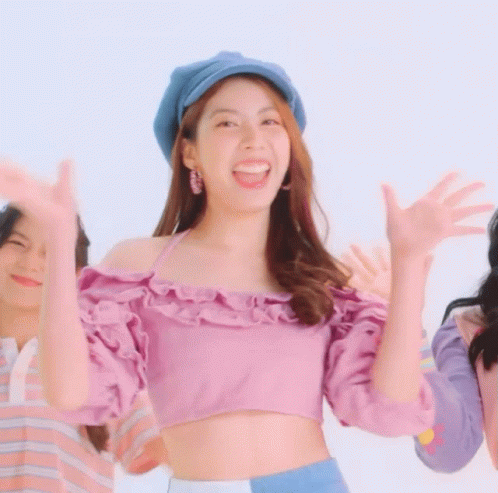 Woman in Purple Crop Top and Blue Hat Smiling