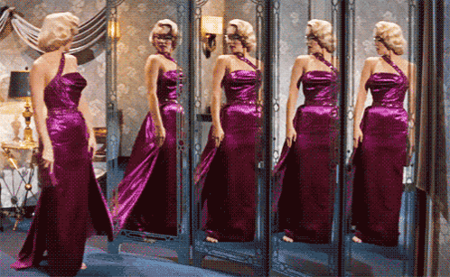 Woman in Purple Dress Looking in Mirror