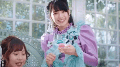 Woman in Purple Dress Smiling Holding Glass