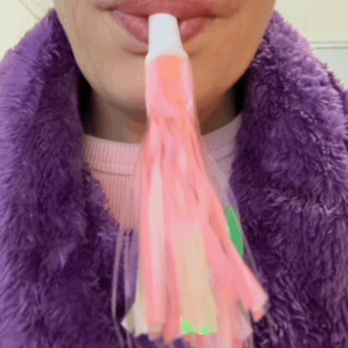 Woman in Purple Fur Coat Holding Party Horn
